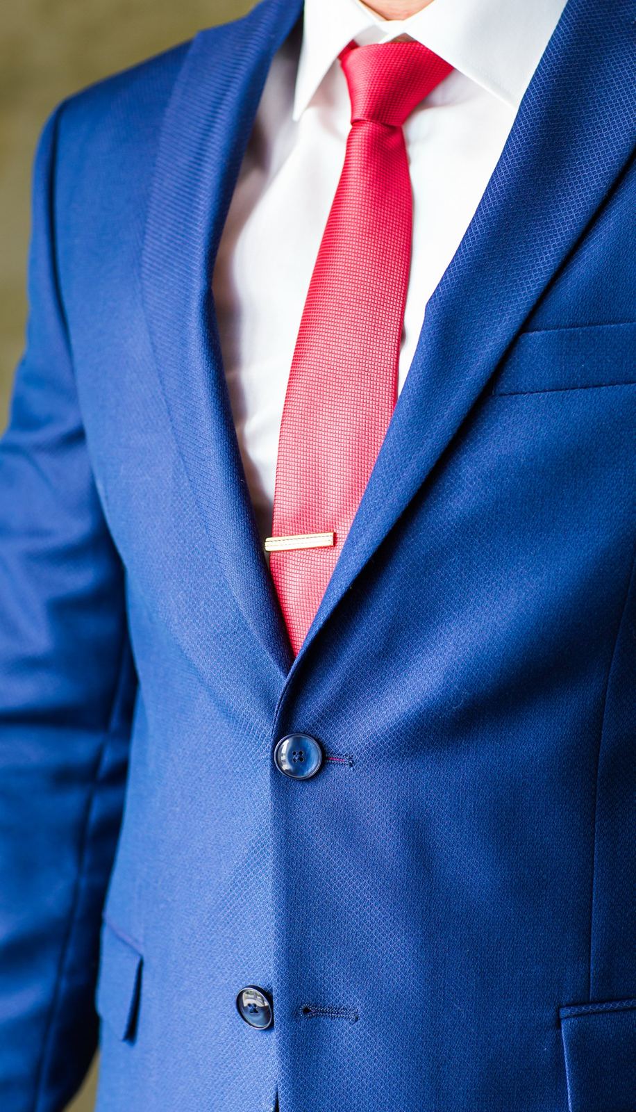 Navy suit jacket and red tie, freshly pressed