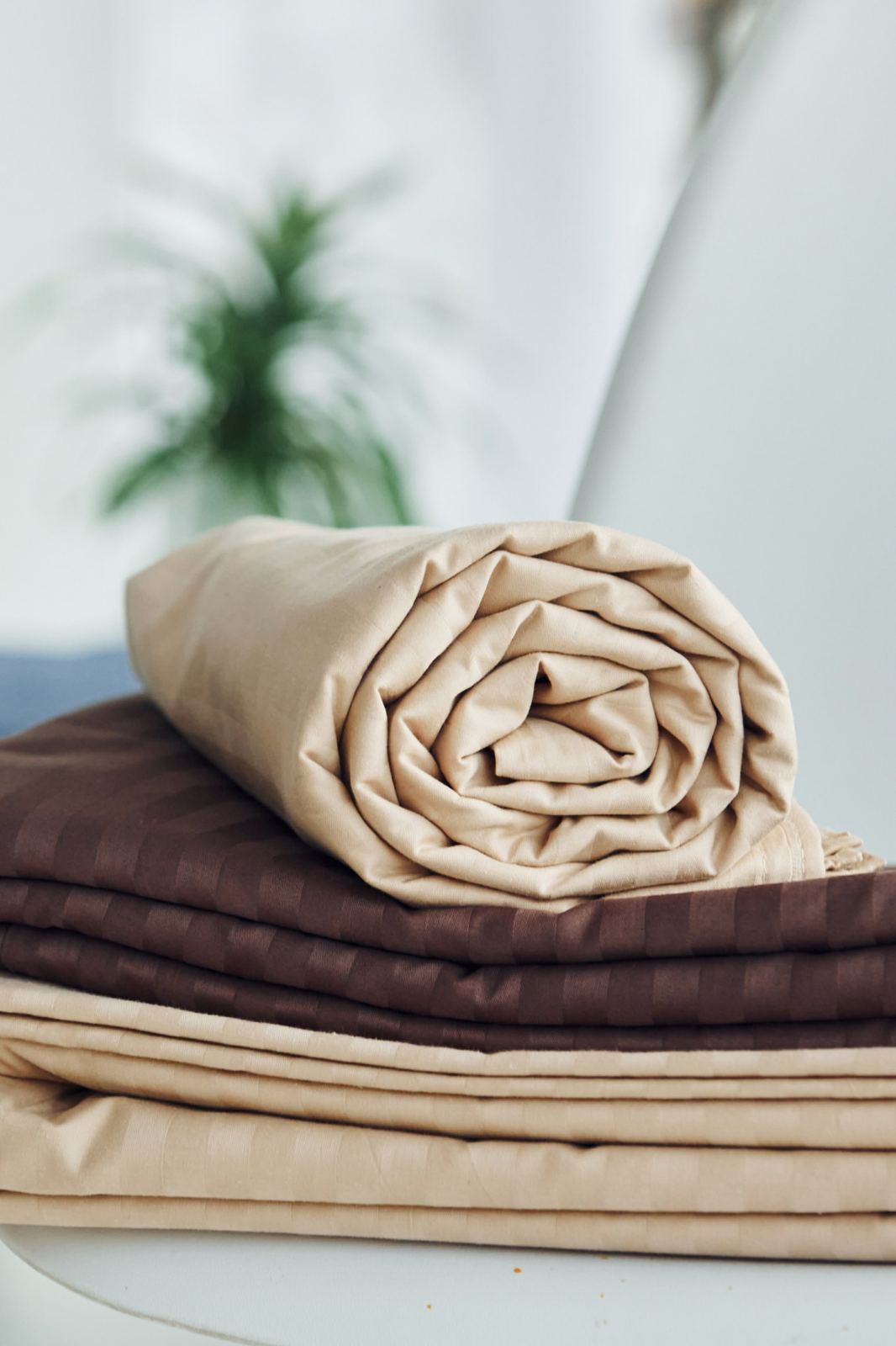 Freshly laundered bed linen, folded and rolled